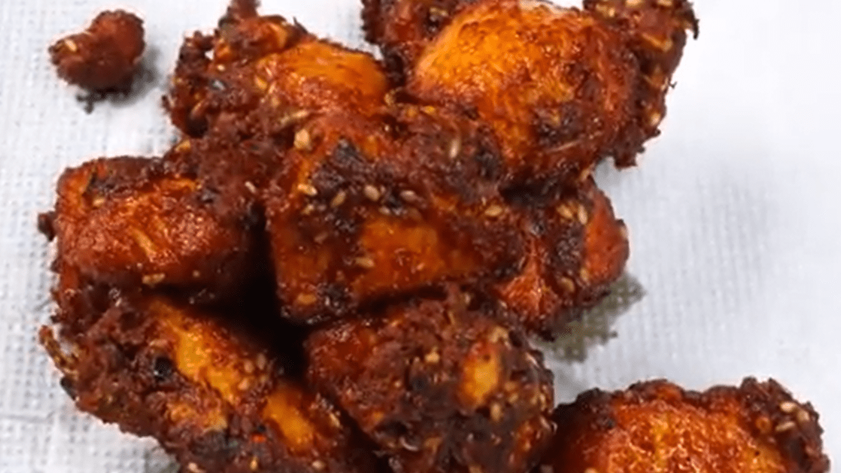 Frying marinated chicken in pan for crispy spicy chicken fry